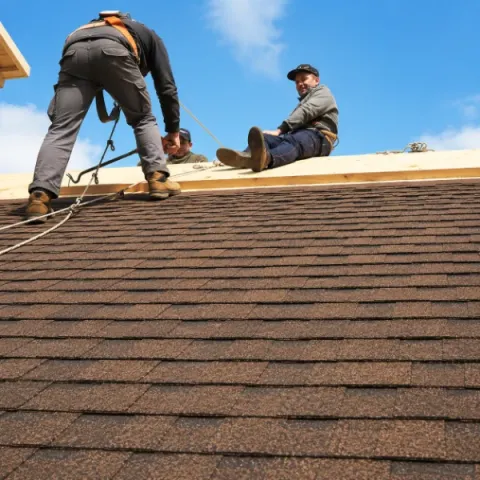 Artisan couvreur réalisant la pose d'une toiture en tuiles